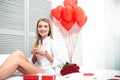 Woman holding cupcake with presents on the bed Royalty Free Stock Photo