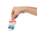 Woman holding cute child sock on white background
