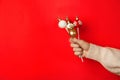 Woman holding delicious Christmas themed cake pops against pink background, closeup. Space for text Royalty Free Stock Photo