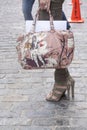 A woman holding a designer handbag and wearing booties Royalty Free Stock Photo