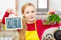 Woman holding diet sign and shopping basket with Royalty Free Stock Photo