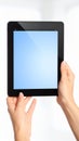 Woman holding digital tablet with blank blue screen, concept for application presentation or design mockup. Royalty Free Stock Photo