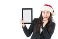 Woman holding digital tablet excited wearing santa hat