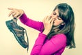 Woman holding dirty stinky shoes - retro style