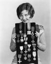 Woman holding display of medals