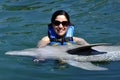 Woman holding a dolphin. Royalty Free Stock Photo