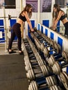 Woman holding dumbbell workout at gym. Dumbbells in sport gym. Royalty Free Stock Photo