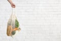 Woman holding Eco cotton shopping bag with fresh and clean vegetables