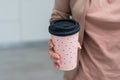 Woman holding elegant thermocup on white background, closeup