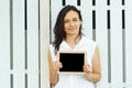 Woman holding empty blackboard with wooden frame. Royalty Free Stock Photo