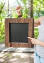 Woman holding empty blackboard with wooden frame. Template Mock Royalty Free Stock Photo