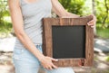 Woman holding empty blackboard with wooden frame. Template Mock Royalty Free Stock Photo