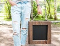 Woman holding empty blackboard with wooden frame. Template Mock Royalty Free Stock Photo