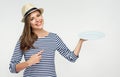 Woman holding empty white plate and pointing finger. Royalty Free Stock Photo