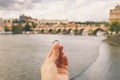 Woman holding an engagement ring front The Charles Bridge. An offer of marriage in Prague, Czech Republic. Royalty Free Stock Photo