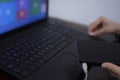 Woman holding external hard drive while plugging cable in the laptop