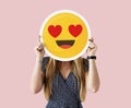 Woman holding a face emoji