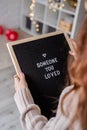 Woman holding felt letter board with the words Someone You Loved Royalty Free Stock Photo