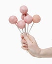 Woman holding a few pink cake pops in hand Royalty Free Stock Photo