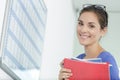 woman holding files stood by calendar wall planner