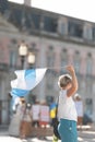 A woman holding a flag of Free Russia at the rally