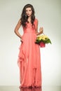 Woman holding flower basket and pulls up her red dress Royalty Free Stock Photo