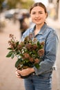 woman holding flower pot with skimmia plant in her hands Royalty Free Stock Photo