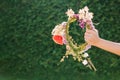 Woman holding flower wreath. Summer solstice day. Midsummer.