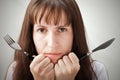 Woman holding fork and knife