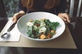 Woman holding fork and knife for preparing to eat Ceasar salad in restaurant Royalty Free Stock Photo