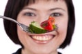 Woman holding fork with salad