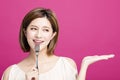 Woman holding fork and showing tasty food Royalty Free Stock Photo