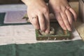 A woman holding a frame for making paper sheets from recycled paper. Selective focus. Household hobby, paper recycling