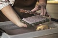 A woman holding a frame for making paper sheets from recycled paper. Selective focus. Household hobby, paper recycling