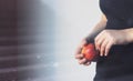 Woman holding fresh apple near window Royalty Free Stock Photo