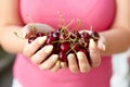 Woman holding fresh cherries