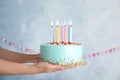 Woman holding fresh delicious birthday cake with candles Royalty Free Stock Photo