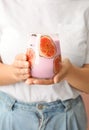 Woman holding fresh fig smoothie, closeup view