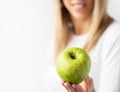 Woman holding fresh green apple Royalty Free Stock Photo