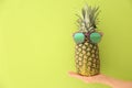 Woman holding fresh ripe pineapple with sunglasses Royalty Free Stock Photo