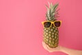 Woman holding fresh ripe pineapple with sunglasses Royalty Free Stock Photo