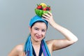 Woman holding fruit bowl over head Royalty Free Stock Photo