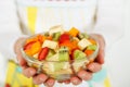 Fruit salad in the hands of women. Royalty Free Stock Photo