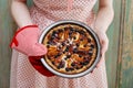 Woman holding fruit tart taken straight out of oven Royalty Free Stock Photo