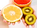 Woman holding fruits kiwi. orange, lemon and grapefruit Royalty Free Stock Photo