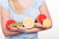 Woman holding fruits kiwi. orange, lemon and grapefruit Royalty Free Stock Photo