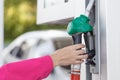 Woman holding a fuel nozzle on the gasoline station Royalty Free Stock Photo