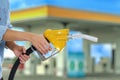 Woman holding fuel nozzle near gas station, closeup Royalty Free Stock Photo