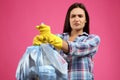 Woman holding full garbage bag against pink, focus on hands Royalty Free Stock Photo