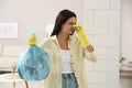 Woman holding full garbage bag at home